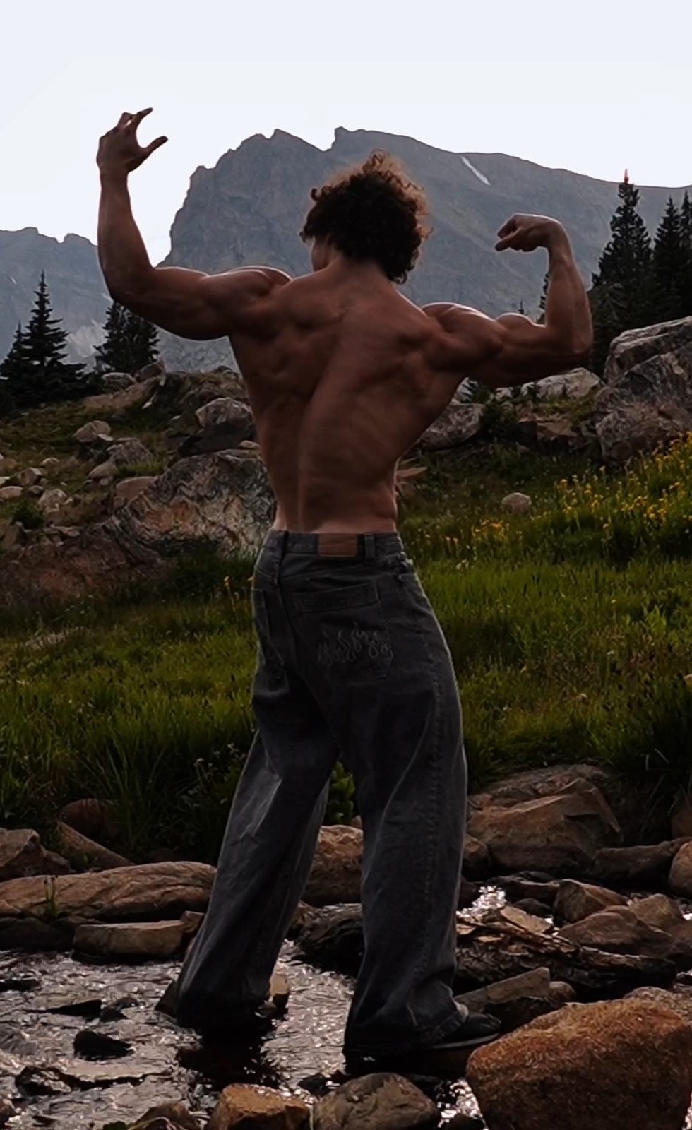 Ben posing from behind in a mountain meadow